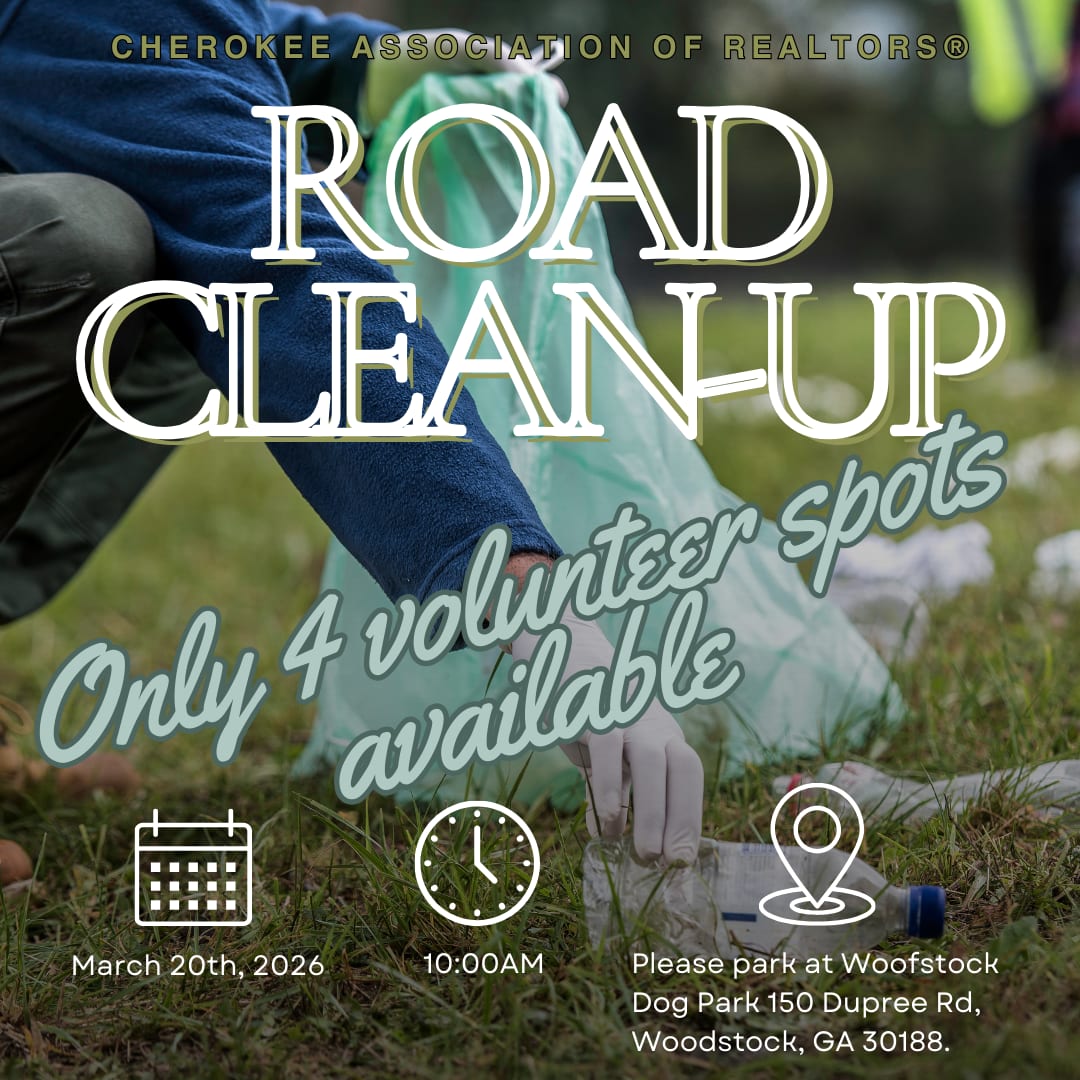 person picking up trash with gloves and a garbage bag